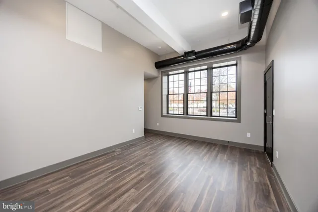 a kitchen with stainless steel appliances kitchen island granite countertop a stove a sink and a refrigerator