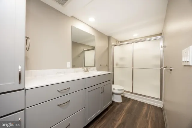 a kitchen with granite countertop a stove a sink and a refrigerator