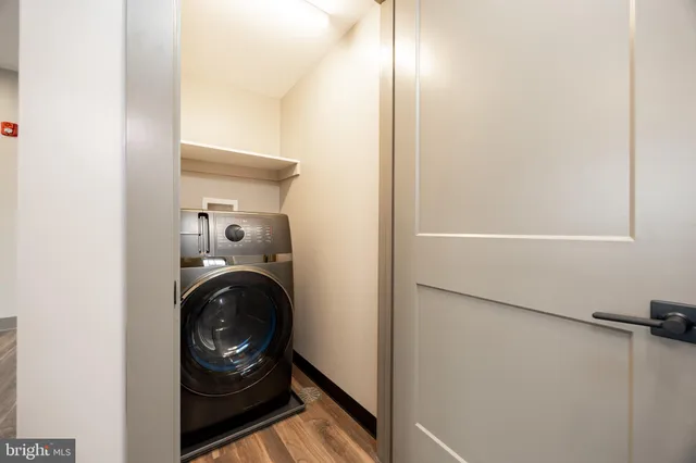 a kitchen with stainless steel appliances a sink a stove a refrigerator and cabinets