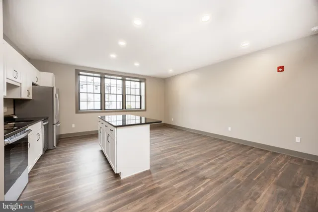 a kitchen with stainless steel appliances a refrigerator a stove top oven a sink and dishwasher