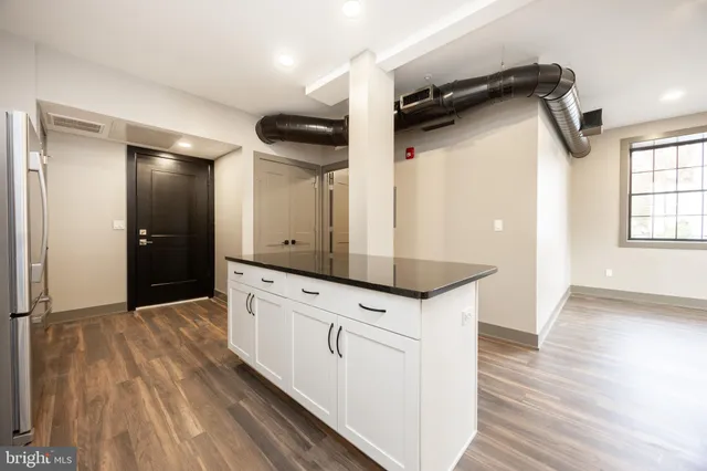 a hallway with wooden floors and white walls