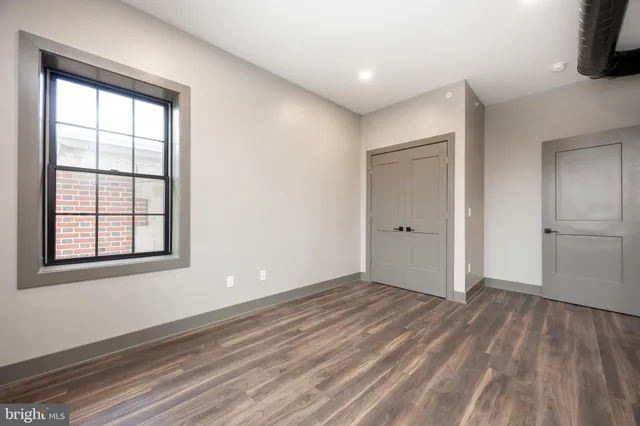 a view of a kitchen with a sink and a refrigerator