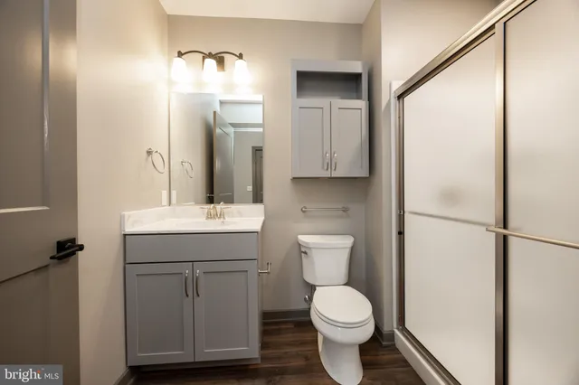 a kitchen with a refrigerator and a stove top oven