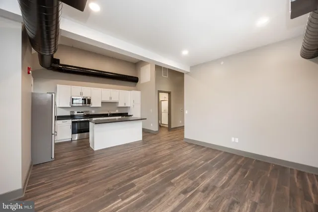 a view of a livingroom with wooden floor and closet