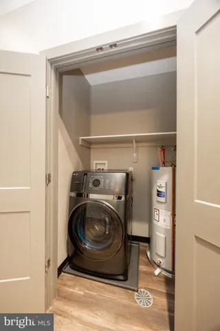 a kitchen with granite countertop a refrigerator and a stove top oven