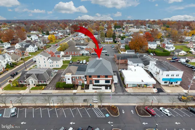 a view of a living room with wooden floor and furniture