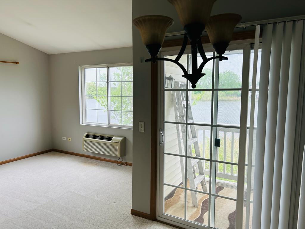 1131 Silverstone Drive, Unit 1131 Carpentersville, IL 60110 - Photo 18 of 23 a view of an empty room with a window