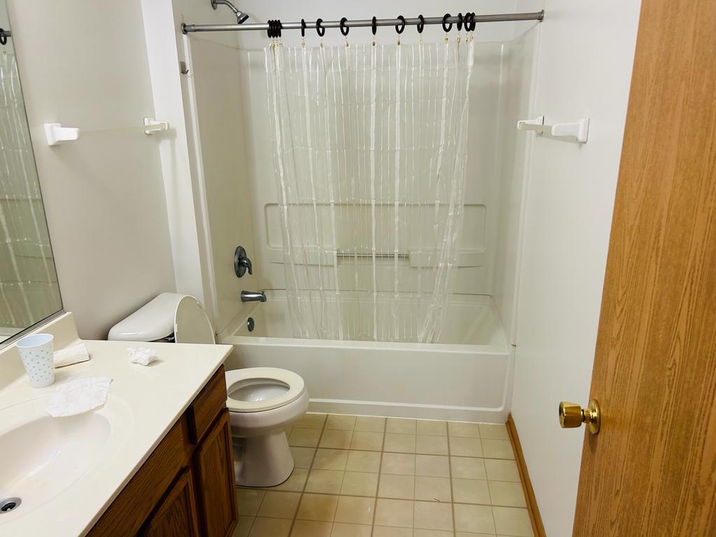 1131 Silverstone Drive, Unit 1131 Carpentersville, IL 60110 - Photo 4 of 23 a bathroom with a sink a toilet and shower