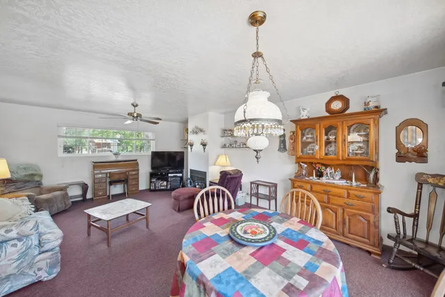 a living room with fireplace furniture and a chandelier