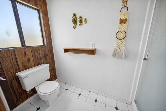 a white toilet sitting next to a white sink