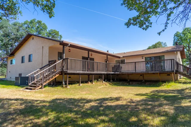 a swimming pool with outdoor seating and yard