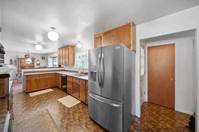 a kitchen with stainless steel appliances a refrigerator and a stove