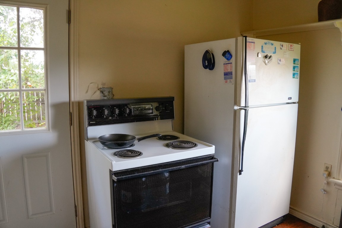 1400 Fm 609 Road Muldoon, TX 78949 - Photo 11 of 24 a white refrigerator freezer and a stove sitting inside of a kitchen