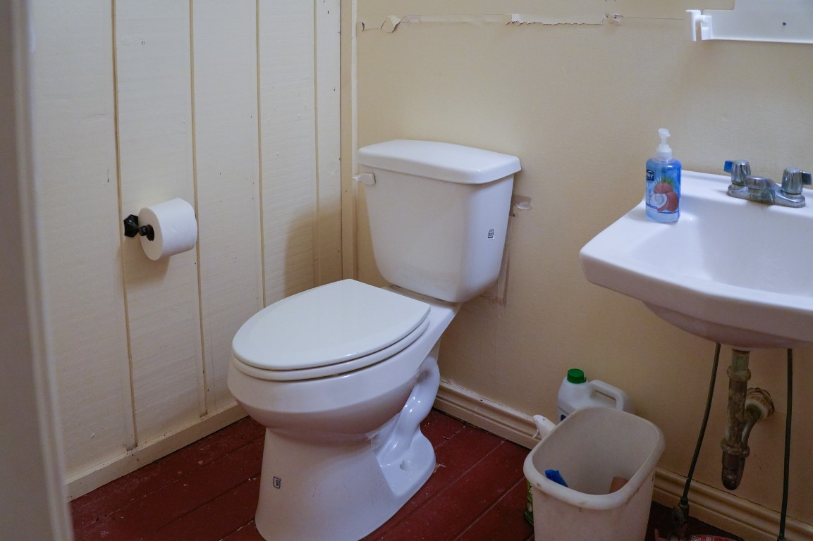 1400 Fm 609 Road Muldoon, TX 78949 - Photo 5 of 24 a white toilet sitting next to a bathroom sink