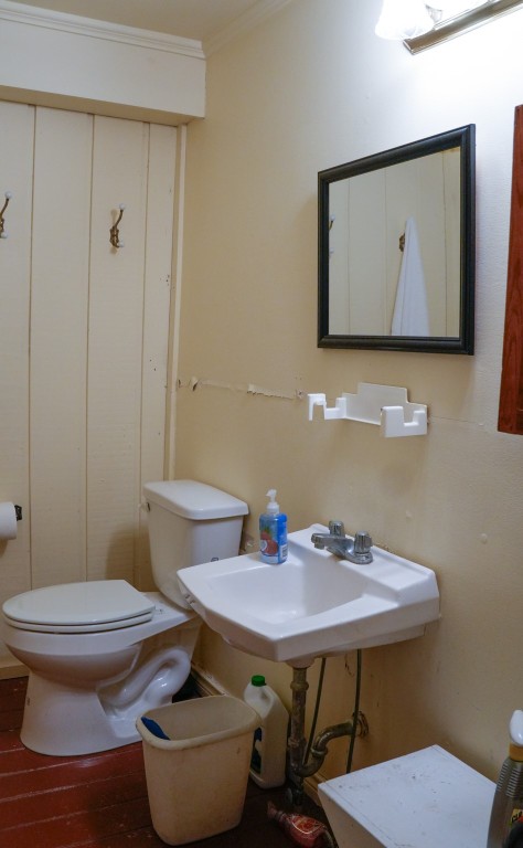1400 Fm 609 Road Muldoon, TX 78949 - Photo 7 of 24 a bathroom with a toilet a sink and mirror