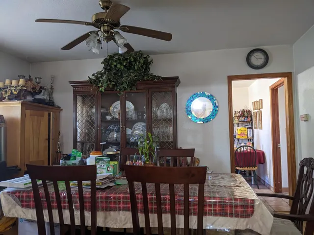 a view of a dining room with furniture and chandelier