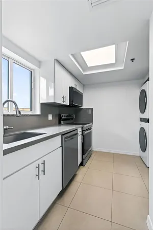 a kitchen with a sink a stove and cabinets
