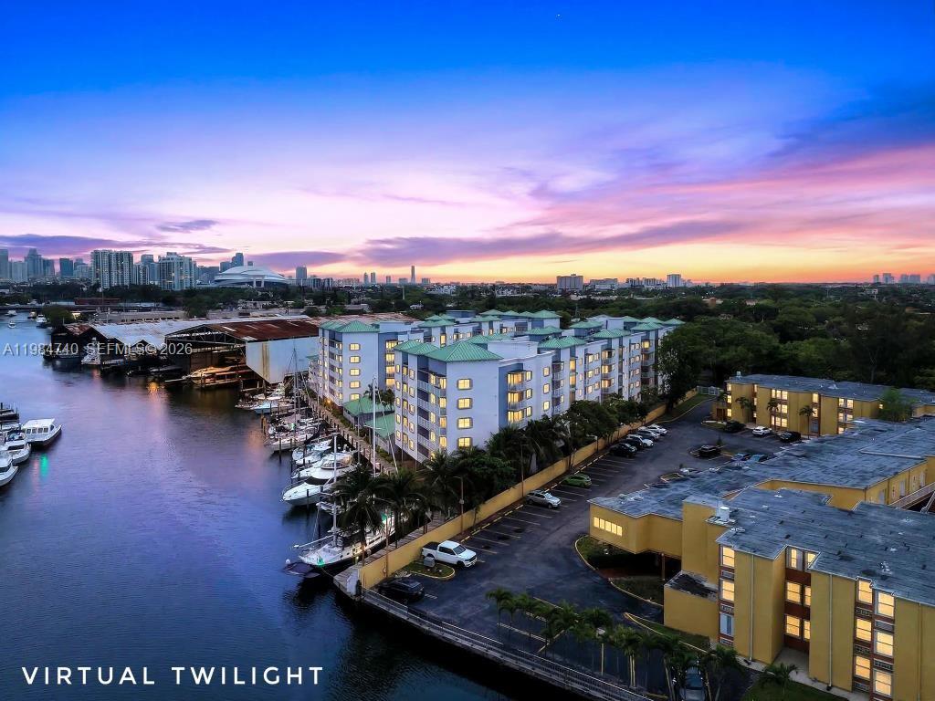 2475 Northwest 16th St Road, Unit 211 Miami, FL 33125 - Photo 2 of 29 a view of a swimming pool with lounge chair