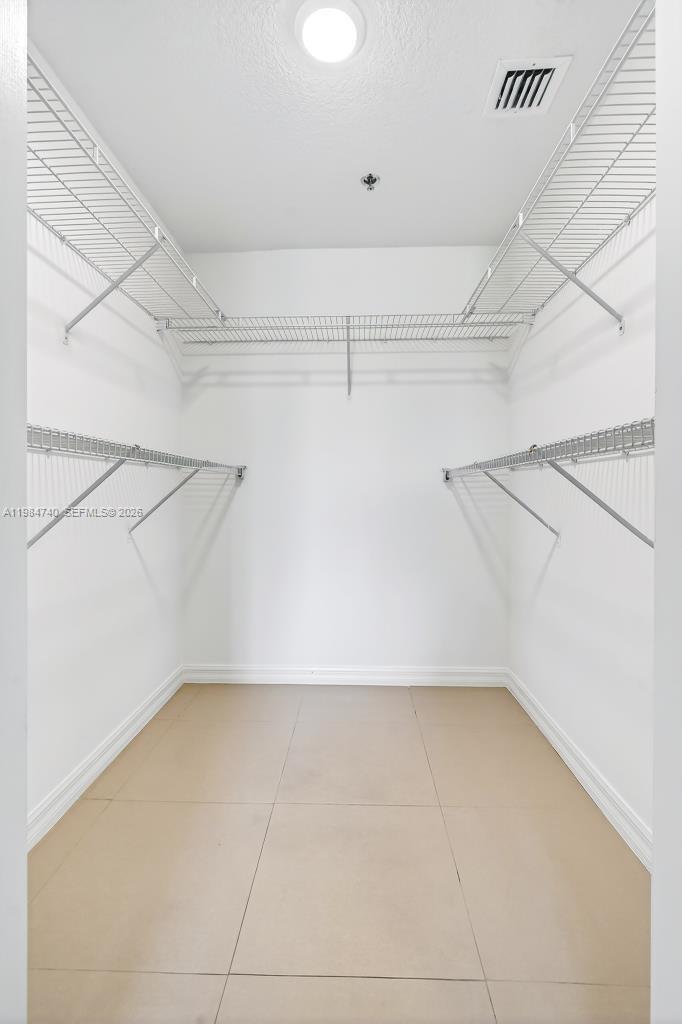 2475 Northwest 16th St Road, Unit 211 Miami, FL 33125 - Photo 24 of 29 a view of a room with racks on the wall