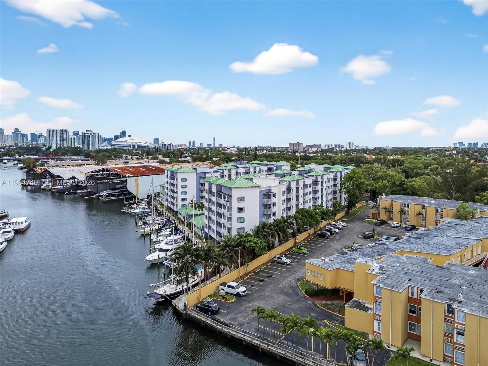 2475 Northwest 16th St Road, Unit 211 Miami, FL 33125 - Photo 25 of 29 a view of a lake with a terrace
