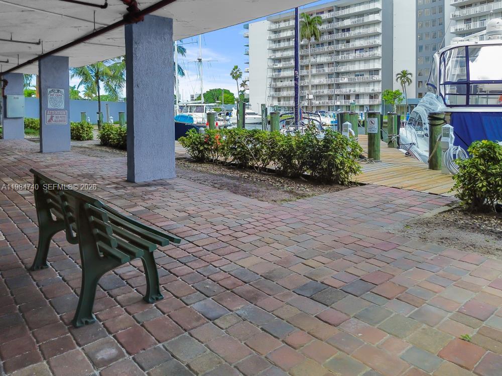 2475 Northwest 16th St Road, Unit 211 Miami, FL 33125 - Photo 27 of 29 a wooden bench sitting in front of a building