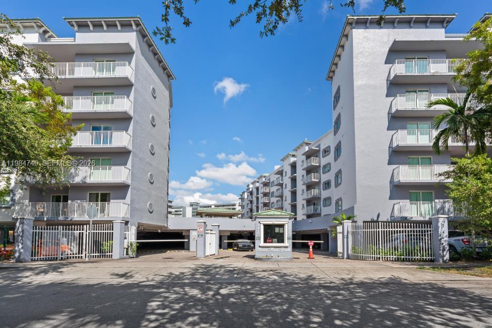 2475 Northwest 16th St Road, Unit 211 Miami, FL 33125 - Photo 3 of 29 a tall building sitting on the side of a street