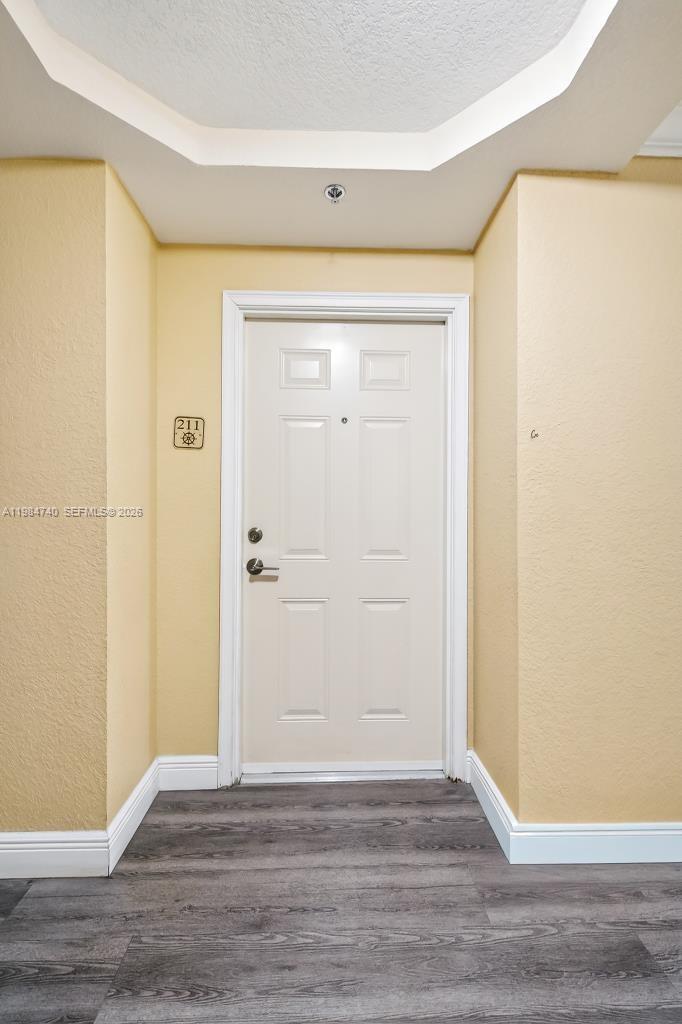 2475 Northwest 16th St Road, Unit 211 Miami, FL 33125 - Photo 6 of 29 a view of an empty room with wooden floor