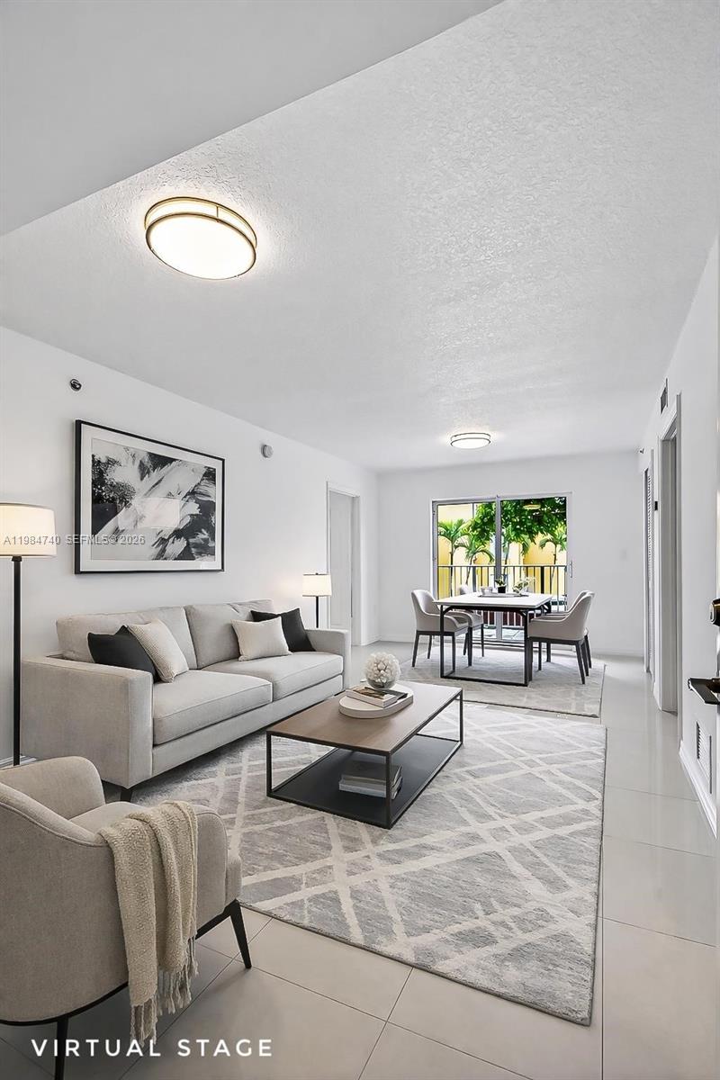 2475 Northwest 16th St Road, Unit 211 Miami, FL 33125 - Photo 10 of 29 a living room with furniture and a large window