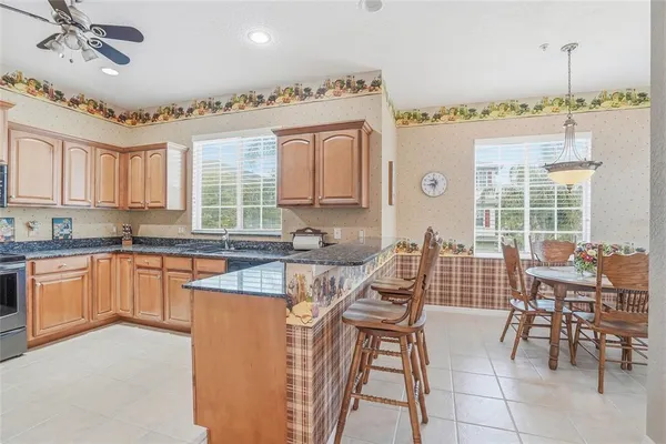 a view of a dining room with furniture and a chandelier