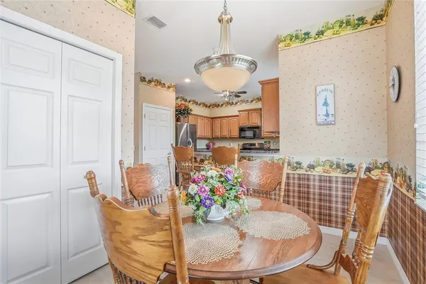 a palm tree sitting in front of a house with a big yard