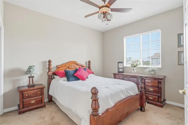 a view of a white building among the yard and palm trees