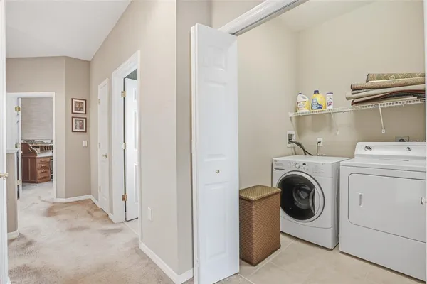 an aerial view of residential houses with outdoor space and parking