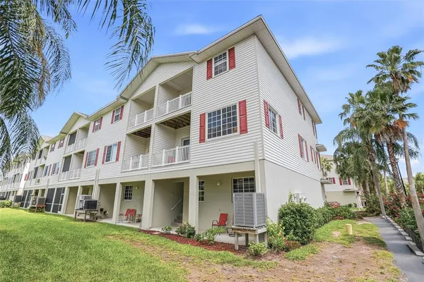 a front view of a house with a yard garage and outdoor seating