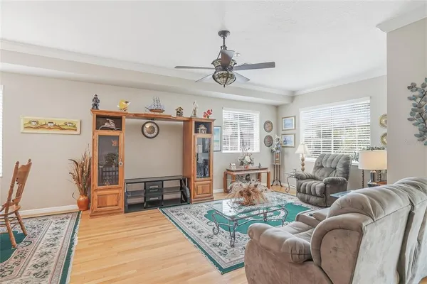 a living room with furniture and a chandelier