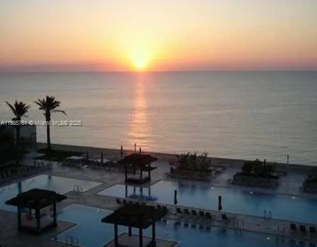 an aerial view of a house with outdoor seating