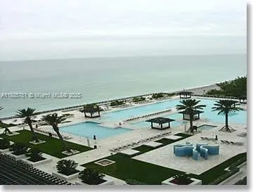 a view of a swimming pool and an outdoor seating