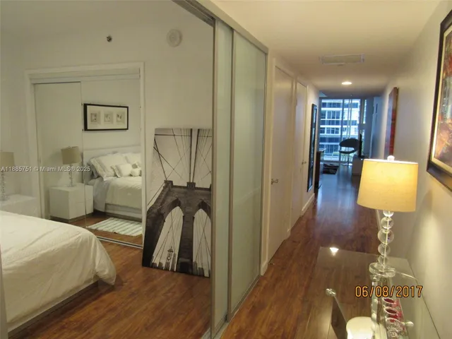 a bedroom with wooden floor and furniture