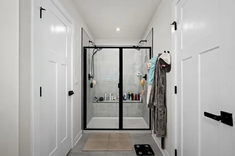a view of a bathroom with a glass door shower