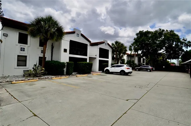 a car parked in front of house with a yard