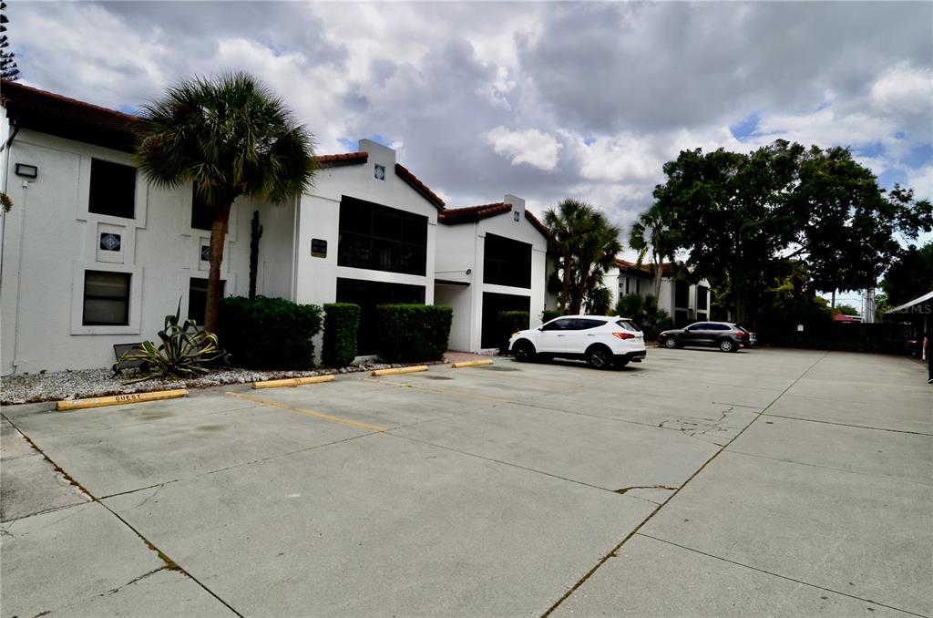 631 North Orange Avenue, Unit 201 Sarasota, FL 34236 - Photo 14 of 14 a car parked in front of house with a yard