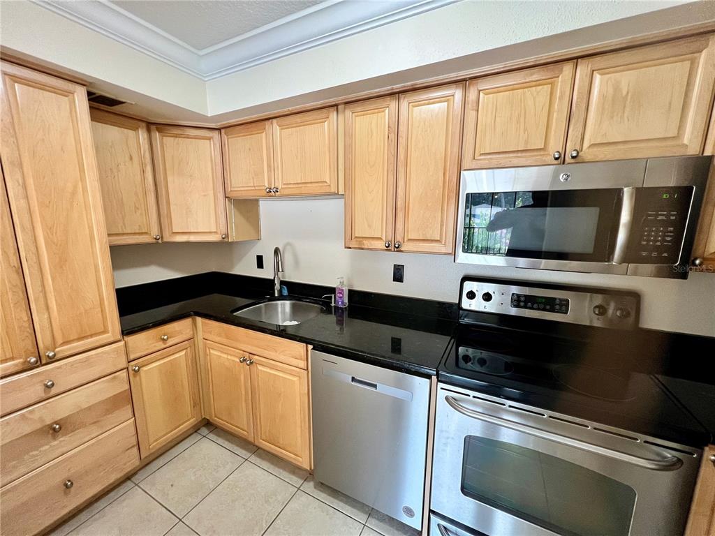 631 North Orange Avenue, Unit 201 Sarasota, FL 34236 - Photo 4 of 14 a kitchen with granite countertop a sink and stainless steel appliances