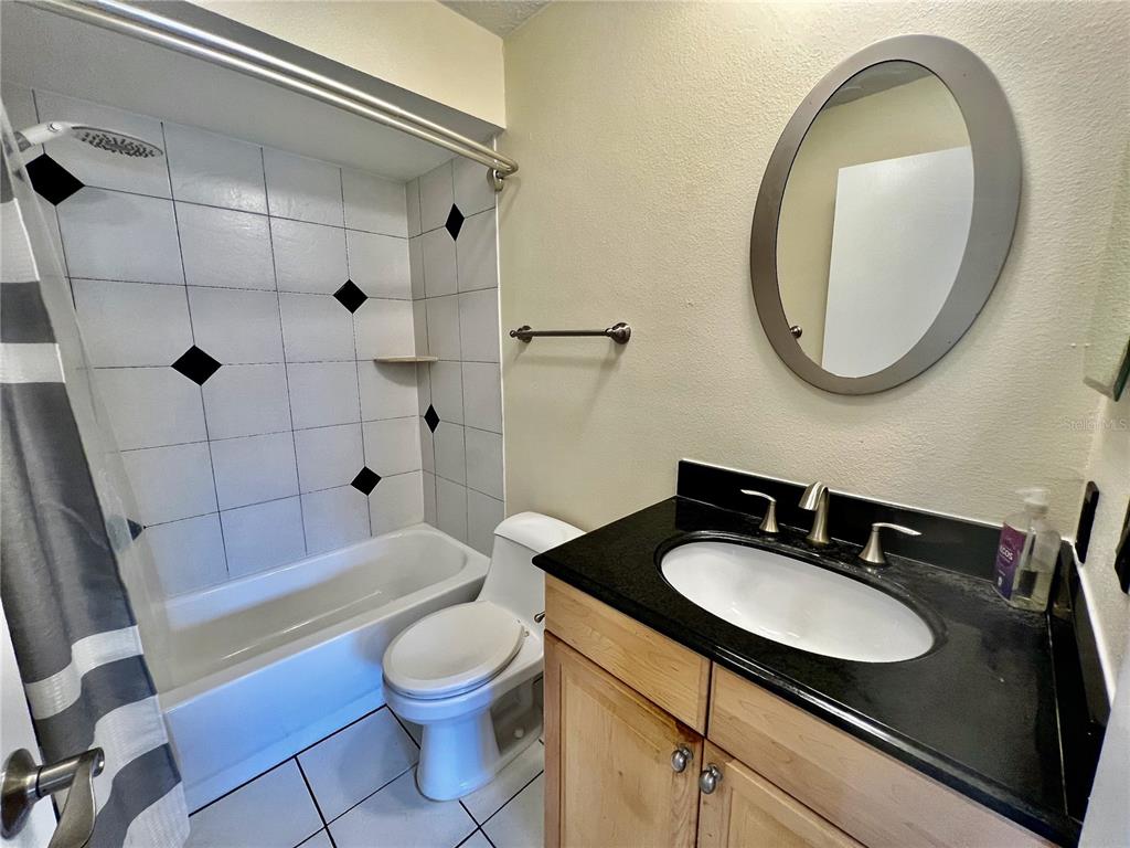 631 North Orange Avenue, Unit 201 Sarasota, FL 34236 - Photo 9 of 14 a bathroom with a sink a toilet and shower