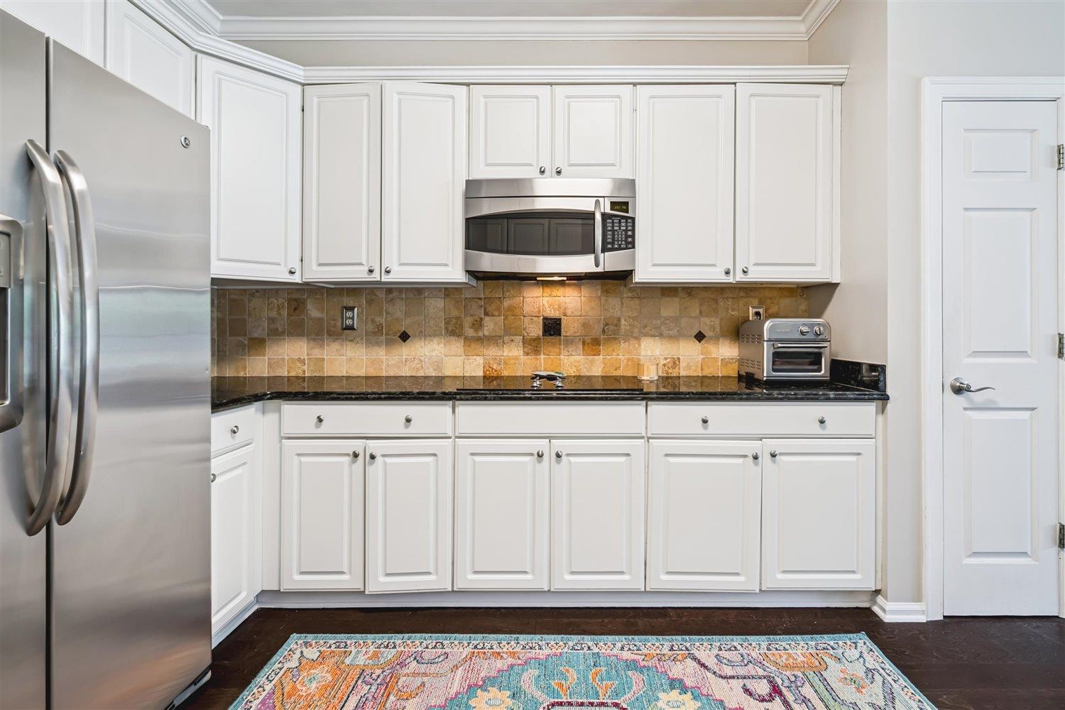 1489 John Ridge Drive Collierville, TN 38017 - Photo 18 of 39 a kitchen with stainless steel appliances granite countertop a refrigerator stove and white cabinets