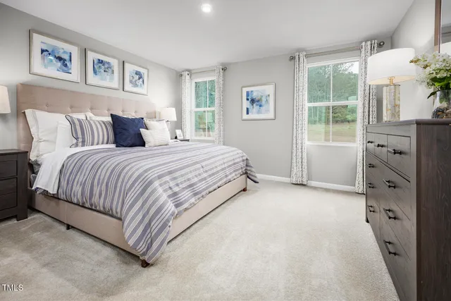 a bedroom with a large bed and a dresser