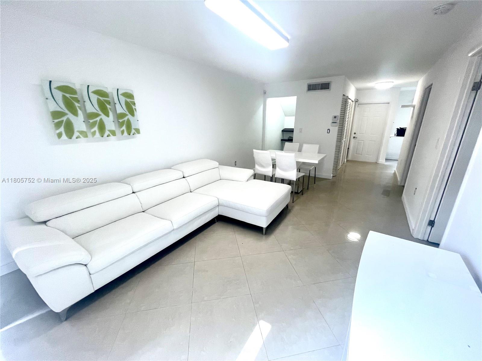 805 Northwest 108th Terrace, Unit 7L5 Pembroke Pines, FL 33026 - Photo 13 of 28 a living room with furniture and a couch