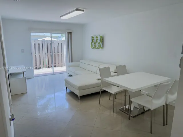 a living room with furniture a window and a table