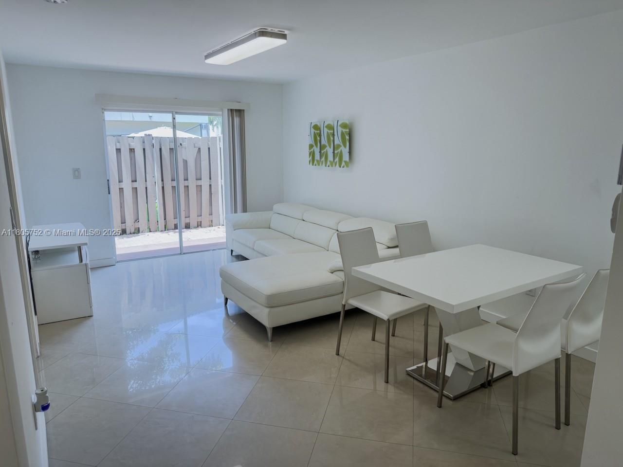 805 Northwest 108th Terrace, Unit 7L5 Pembroke Pines, FL 33026 - Photo 14 of 28 a living room with furniture a window and a table