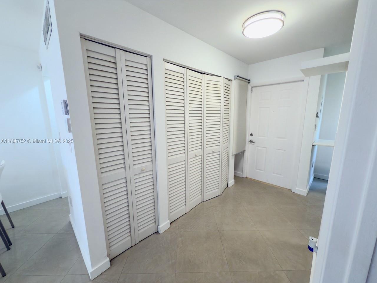805 Northwest 108th Terrace, Unit 7L5 Pembroke Pines, FL 33026 - Photo 16 of 28 an empty room with a chair