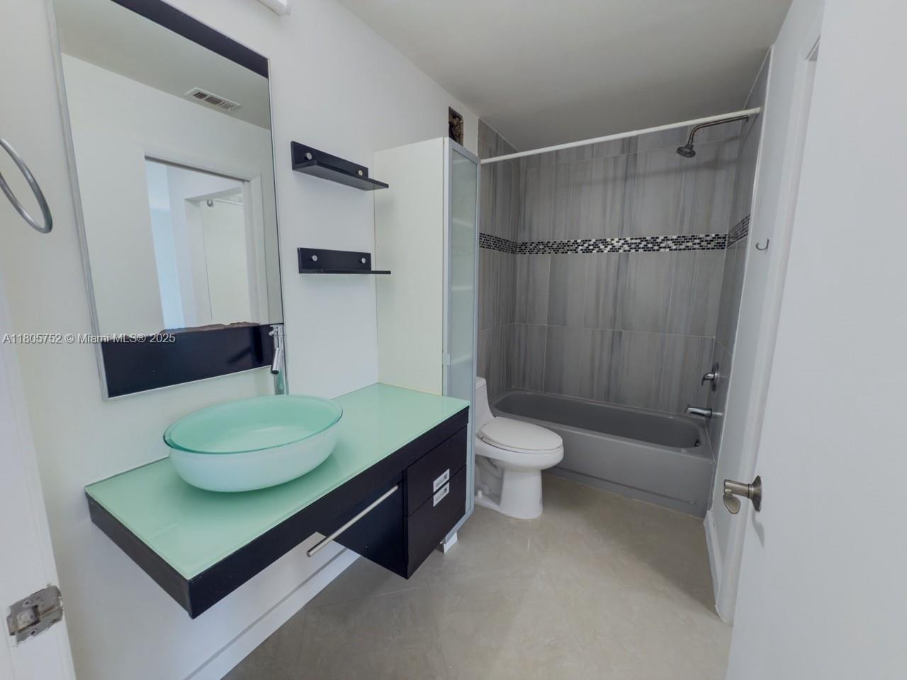 805 Northwest 108th Terrace, Unit 7L5 Pembroke Pines, FL 33026 - Photo 17 of 28 a bathroom with a sink a toilet and shower