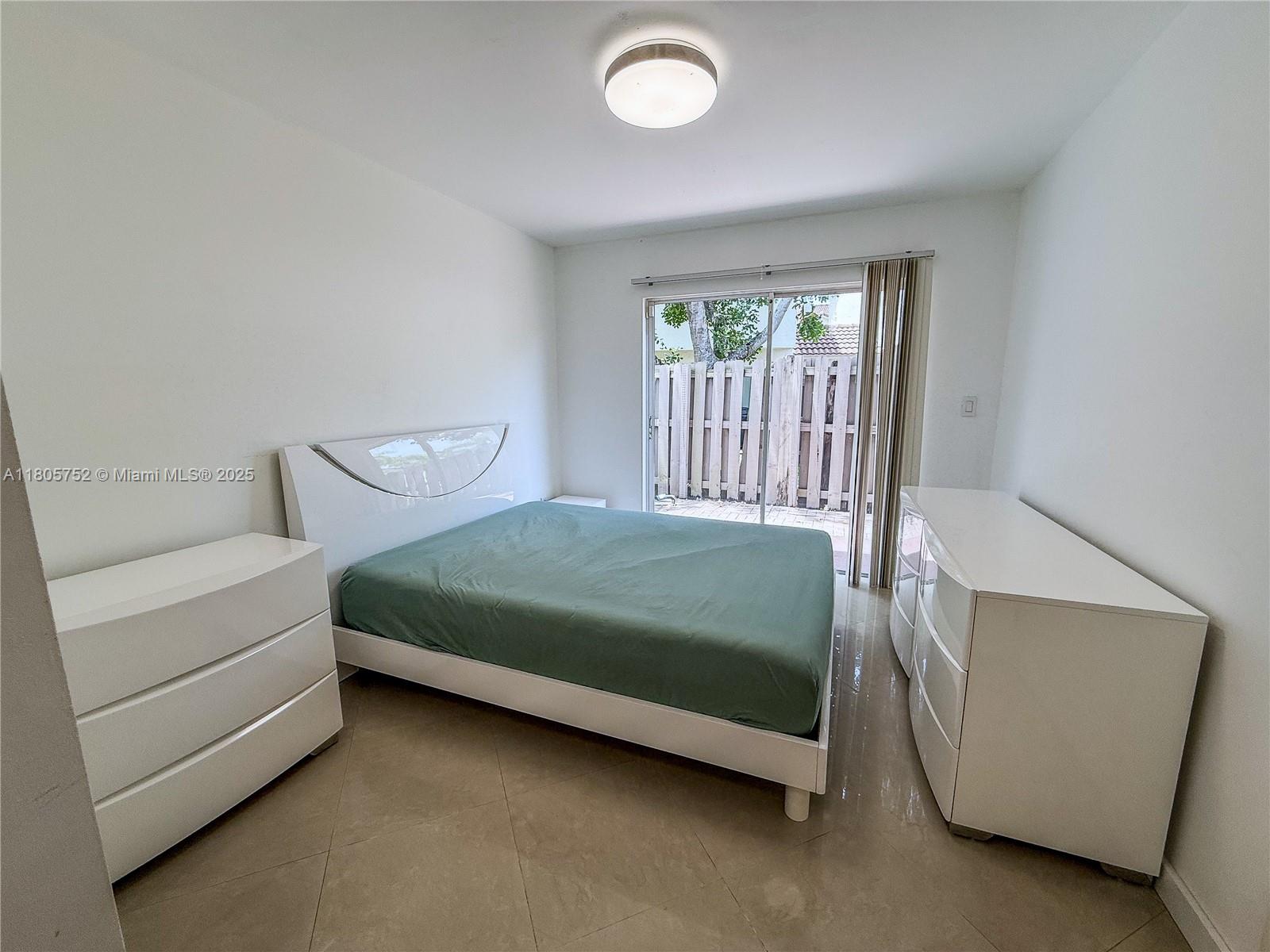 805 Northwest 108th Terrace, Unit 7L5 Pembroke Pines, FL 33026 - Photo 18 of 28 a bedroom with a bed and a window